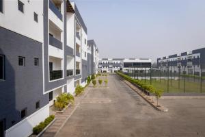 an empty courtyard of a building with plants at D'Crown Place in Abuja