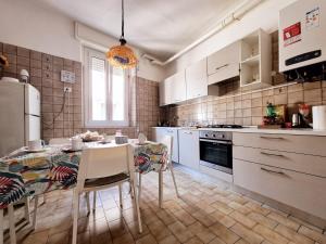 a kitchen with a table with chairs and a refrigerator at Camera con Vista B&B in Ancona