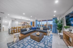 a living room with a blue couch and a table at Top Deck Estate in Siesta Key