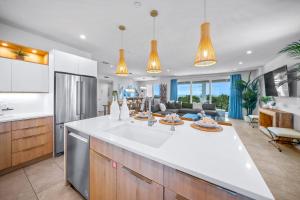 a kitchen with a white counter top and a living room at Top Deck Estate in Siesta Key