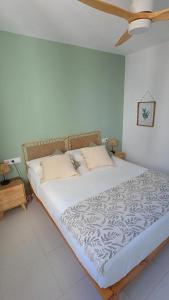 a bedroom with a large bed with white sheets and pillows at HOLIDAYS MENORCA Cala Galdana in Cala Galdana
