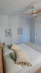 a white bed with pillows on it in a bedroom at HOLIDAYS MENORCA Cala Galdana in Cala Galdana +6 photos