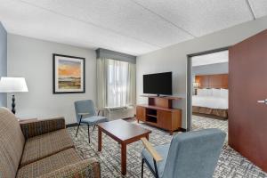 a hotel room with a couch and a bed at Best Western Plus Fresno Airport Hotel in Fresno