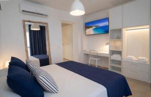 a bedroom with a large bed with blue pillows at Casa Pomonte in Pomonte