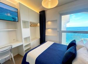 a bedroom with a bed and a large window at Casa Pomonte in Pomonte +17 photos