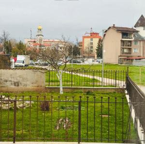 a park with a tree and a fence at Димоли in Elin Pelin