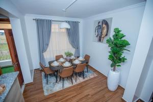 a dining room with a table and chairs at The Prestige Hub Residences in Eldoret