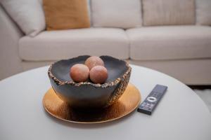 a black bowl on a table next to a remote control at The Prestige Hub Residences in Eldoret +18 photos