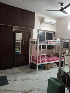 a bedroom with two bunk beds in a room at SUMATHY GIRLS HOSTEl in Chennai