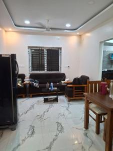 a living room with a marble floor at SUMATHY GIRLS HOSTEl in Chennai