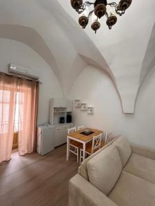 a living room with a couch and a table at Casa Vacanza Pietre & Cielo in Ceglie Messapica