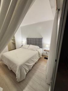 a bedroom with a large white bed and a table at San Miguel Apartment Ocean Magic in Lima
