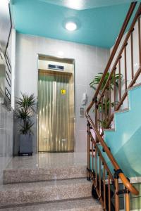 a elevator in a building with stairs and a door at DreamTrip Guesthouse in Incheon