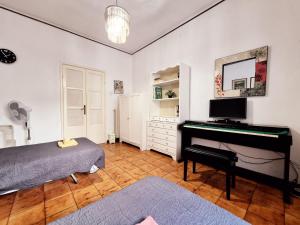 a bedroom with a piano and a bed and a mirror at Camera con Vista B&B in Ancona