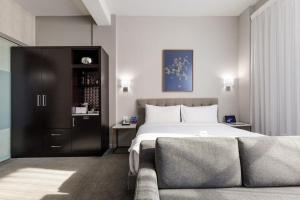 a hotel room with a bed and a couch at Stanton House El Paso in El Paso