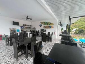 a dining room with black tables and chairs at Villa Trajano Resort in San Antonio