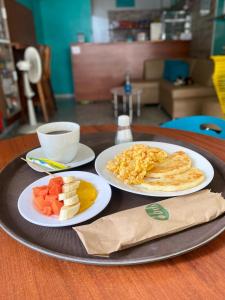 a tray with two plates of food on a table at Hotel Casa Martina Valledupar in Valledupar