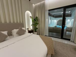 a bedroom with a white bed and a living room at Quiet House villa in Hatta +30 photos