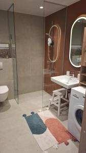 a bathroom with a sink and a washing machine at New delux appartement in Keila