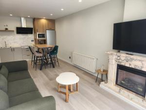 a living room with a couch and a fireplace at CREDENCIAL Bulevar in Sarria +16 photos
