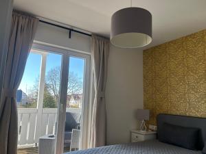 a bedroom with a bed and a large window at Villa Waldblick Baabe in Baabe