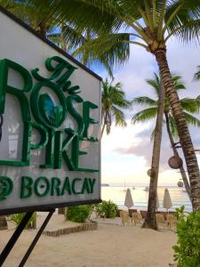 a sign on the beach with a ritz dip bar grocery at The Rose Pike at Boracay in Boracay