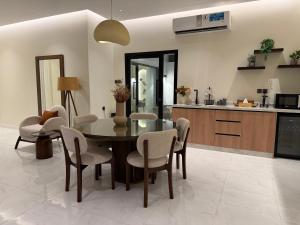 a kitchen and dining room with a table and chairs at Quiet House villa in Hatta