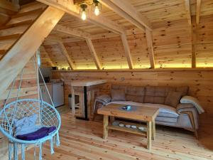 a living room with a couch and a table at Eco resort Komarnica in Šavnik