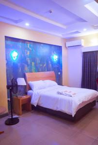 a bedroom with a bed with a fish tank on the wall at Boripe Hotel And Suites, Oluponna, Osun State in Olupona