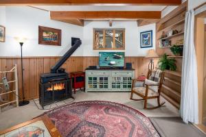 a living room with a fireplace and a television at The Gingerbread Cottage in Kings Beach