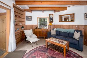 a living room with a blue couch and a table at The Gingerbread Cottage in Kings Beach