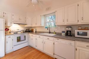 a white kitchen with white appliances and a window at Sparrow's Rest - Duck, Sanderling, 350 Yards to the Beach, Community Pool, YR Flex Stays in Duck +51 photos