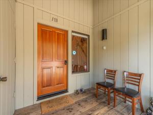 a room with two chairs and a wooden door at Bear's Den in Kings Beach