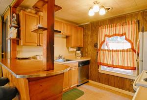 a small kitchen with wooden cabinets and a window at McCarthy Place in Tahoe Vista