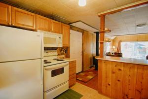 a kitchen with white appliances and wooden cabinets at McCarthy Place in Tahoe Vista