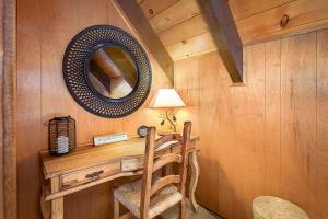 a room with a desk with a mirror and a chair at Honey Bear Cabin in Carnelian Bay