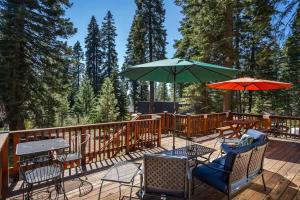 a deck with chairs and tables and umbrellas at Honey Bear Cabin in Carnelian Bay +38 photos