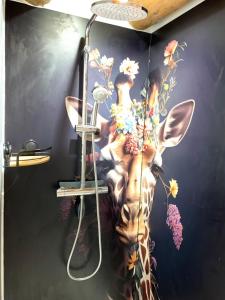 a painting of a giraffe on a wall at Le Garage in Lamotte-Beuvron +17 photos