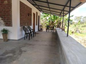 a porch of a house with chairs and tables at Evara Homestay in Monaragala