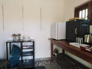 a kitchen with a counter with a microwave on a table at Evara Homestay in Monaragala