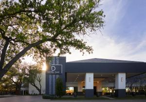 a building with a sign that reads d hospital at Hotel Dax in Addison