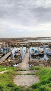 a dock with boats on a body of water at Casa Nonno Maiti in Scardovari