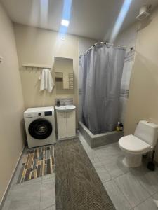 a bathroom with a toilet a sink and a shower at Straume in Valmiera