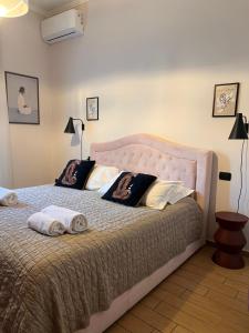 a bedroom with a large bed with two pillows at Appartamento Nicole 20 in Menaggio