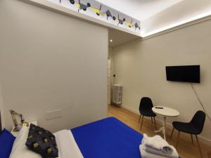 a bedroom with a bed and a tv and a table at Short Lets Grandi Stazioni in Bari