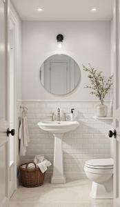 a bathroom with a sink and a toilet and a mirror at The Highfield - Self Check-in Hotel in Keswick
