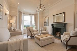a living room with a couch and a fireplace at The Highfield - Self Check-in Hotel in Keswick +7 photos