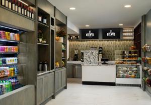 a kitchen with a counter in a store with food at Hotel Dax in Addison +90 photos