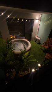a bathroom with a bath tub with plants and lights at AH Radnica Spa Jacuzzi , Home Theatre in Košice