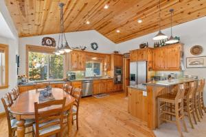 a kitchen with wooden cabinets and a table and chairs at Cascade Woods in Tahoma